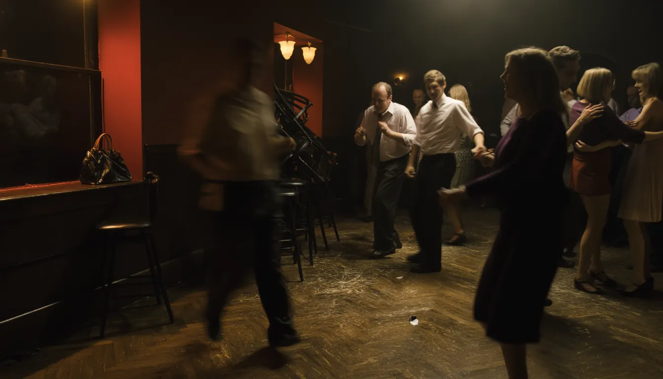 A small worn dance floor in a suburban pub late on a Saturday night, eight or nine adults of mixed ages dancing loosely.
